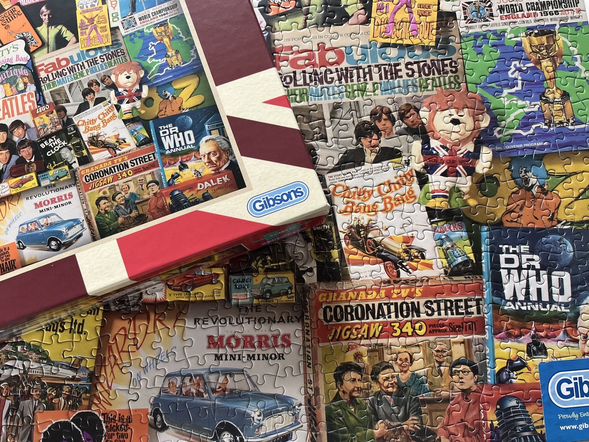 Collection of vintage-style jigsaw puzzles with colorful graphics and Gibsons branding