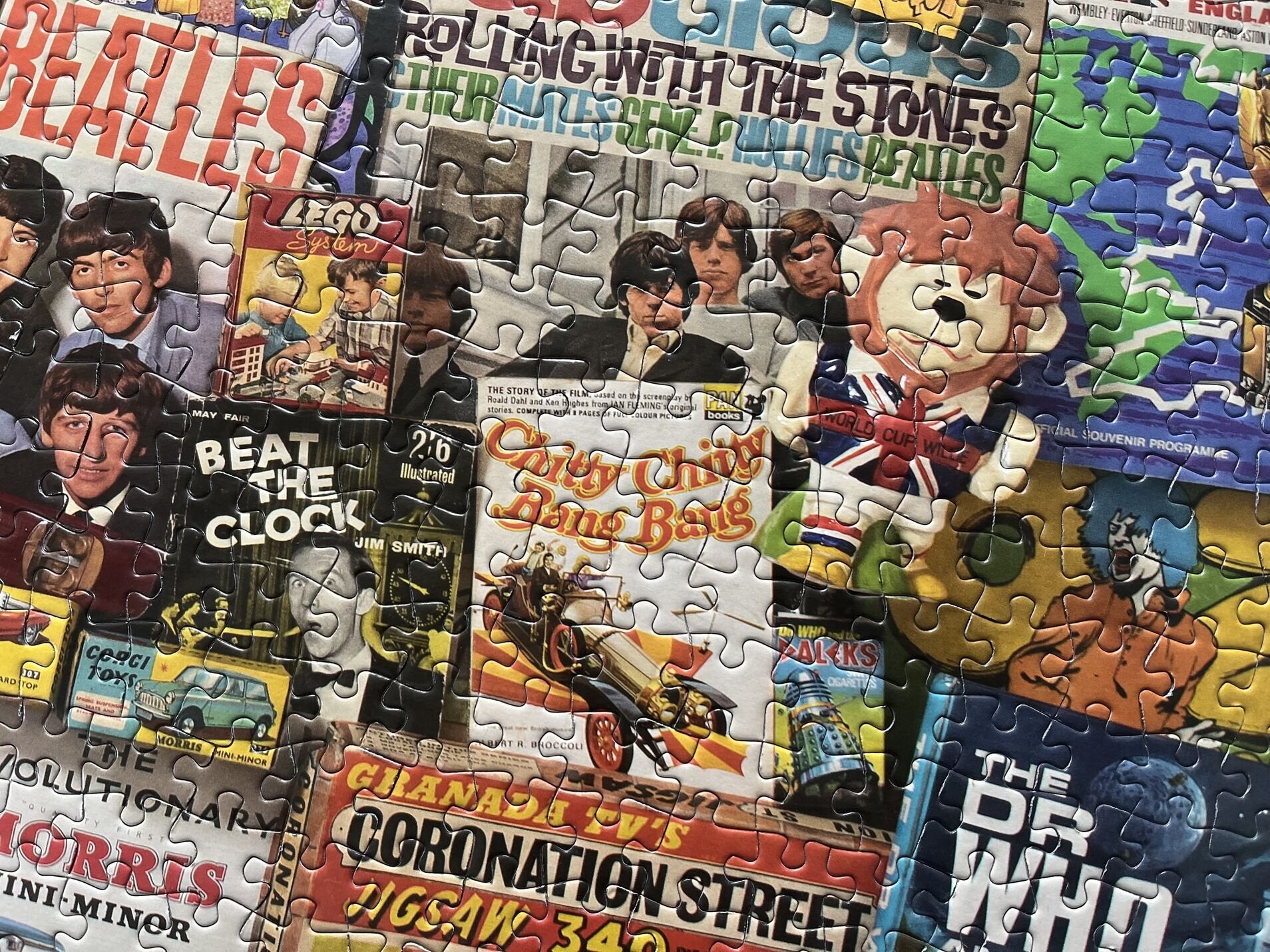 Jigsaw puzzle with various album cover designs, including The Beatles and Rolling Stones.