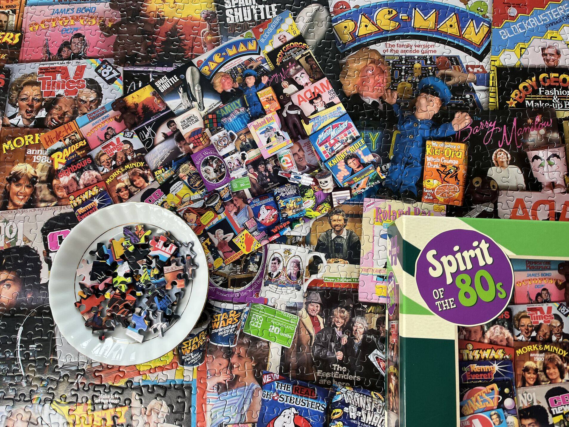 Collection of vintage video game boxes and a bowl of small figurines on a collage background.