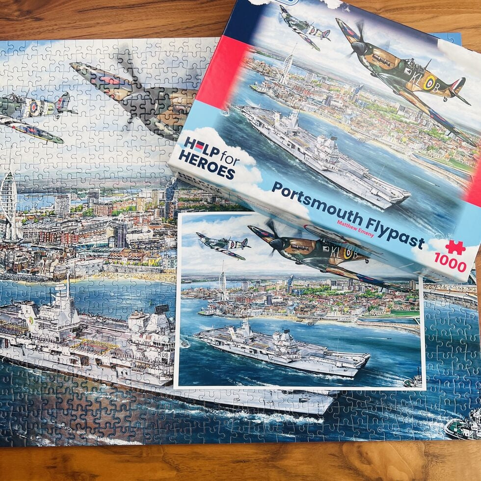 Portsmouth Flypast 1000 piece jigsaw puzzle made up on wooden table with poster and retail box