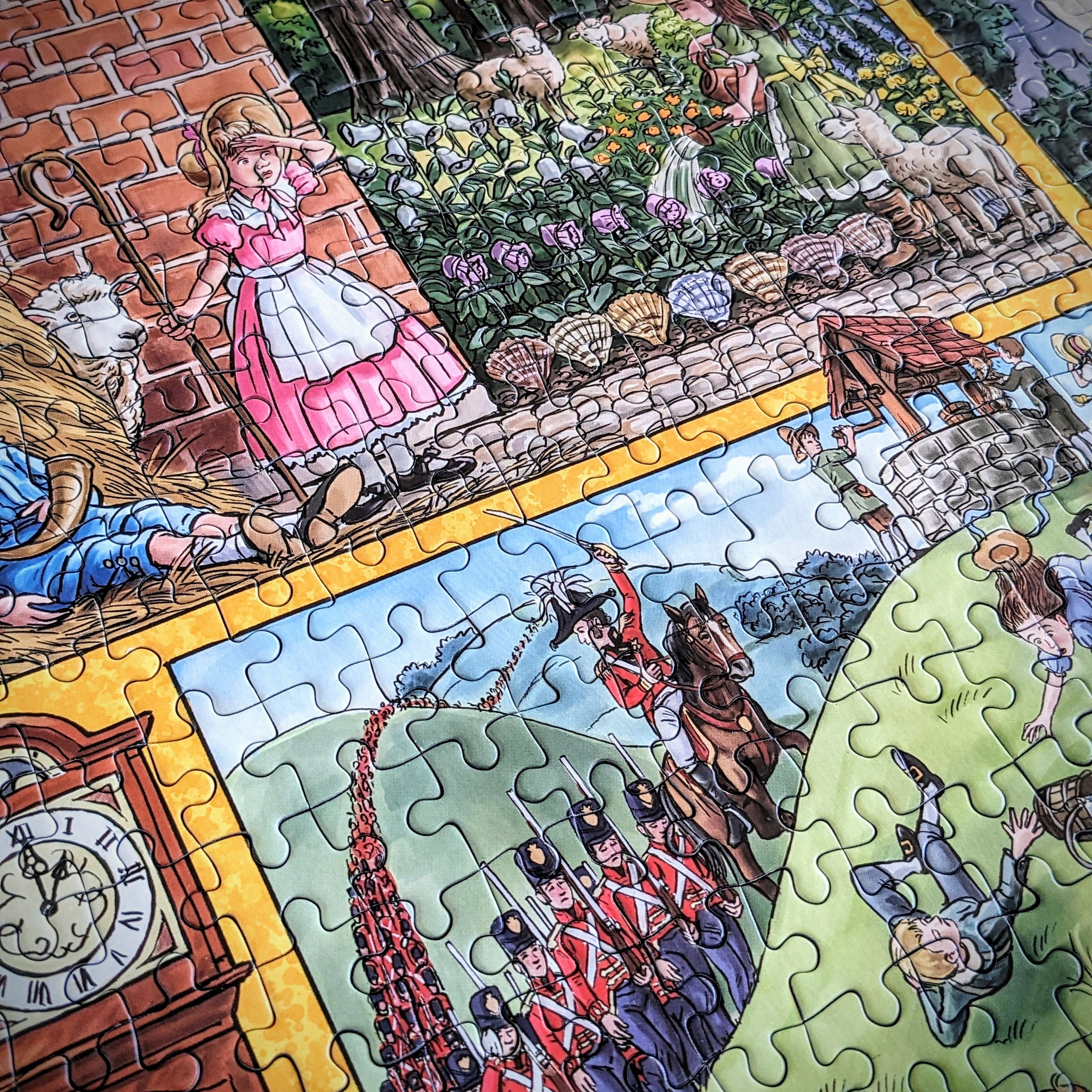 A close-up of a colourful illustrated jigsaw puzzle showing multiple scenes: a girl in a pink dress by a brick wall, flowers and animals in a garden, a clock face, soldiers in red uniforms, and other vintage-style drawings separated by puzzle-piece seams.
