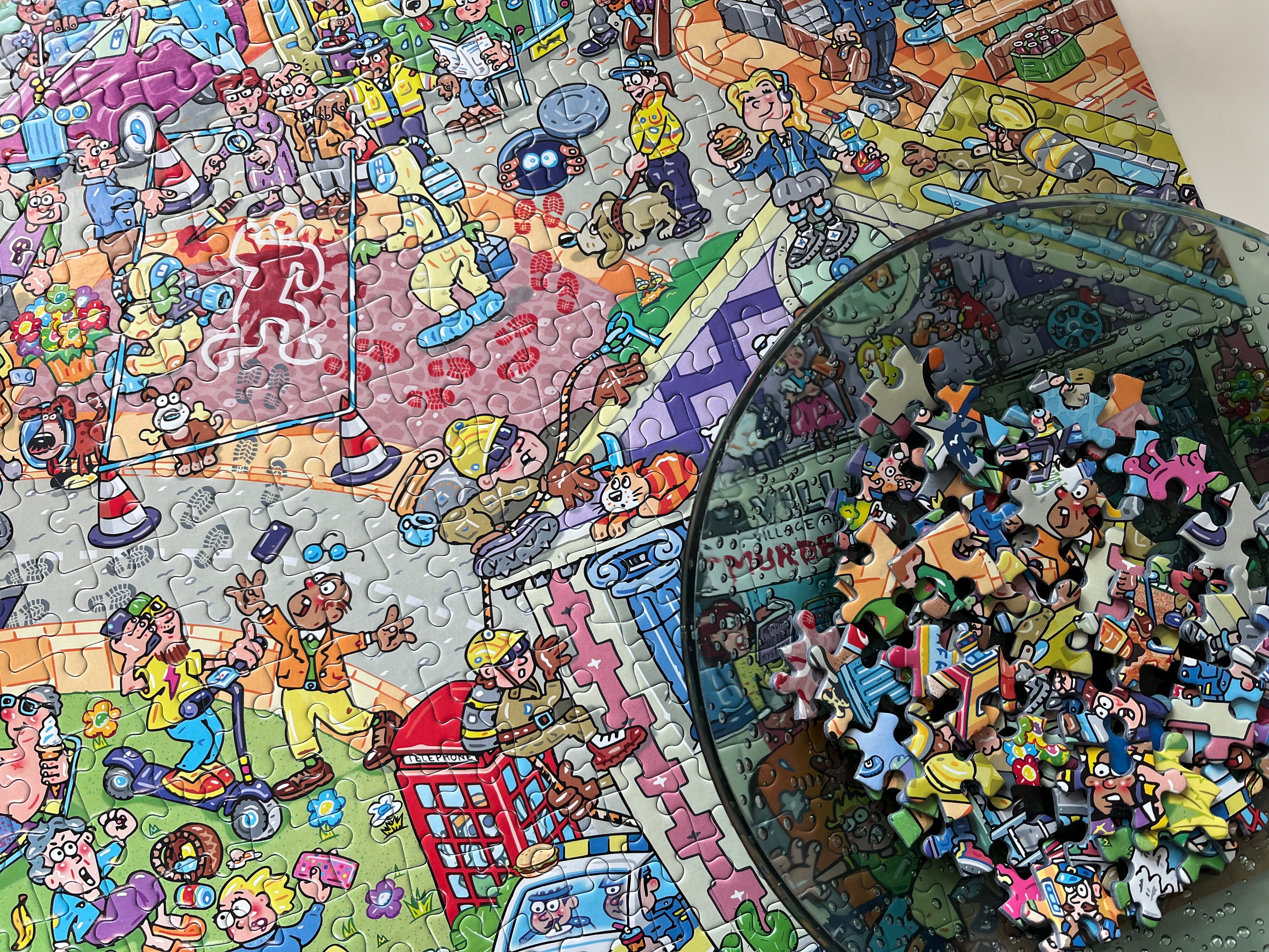 A colourful jigsaw puzzle featuring a busy cartoon city scene with many characters and objects, shown with a clear round bowl filled with loose puzzle pieces on a light surface.