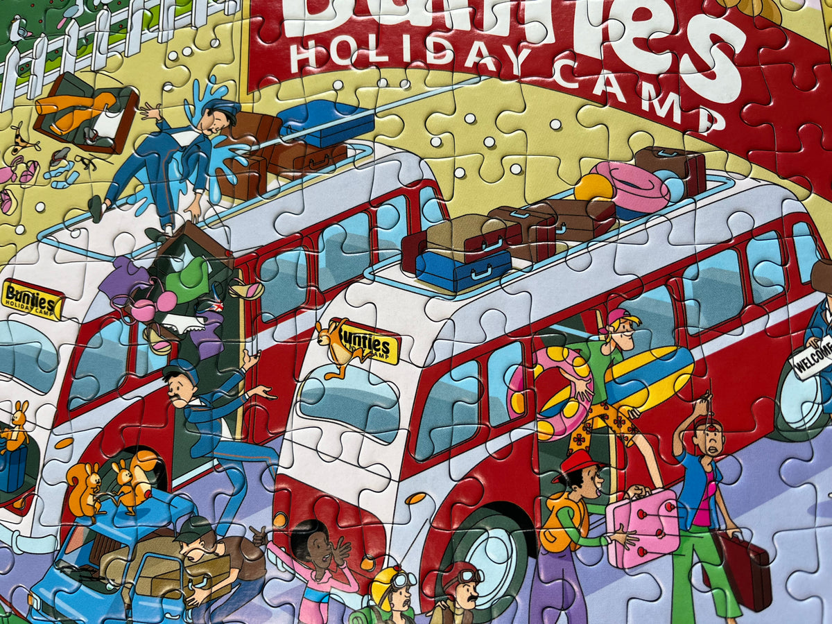 Jigsaw puzzle of a red double-decker bus with people on a yellow background, featuring the text 'Bumbles Holiday Camp'.