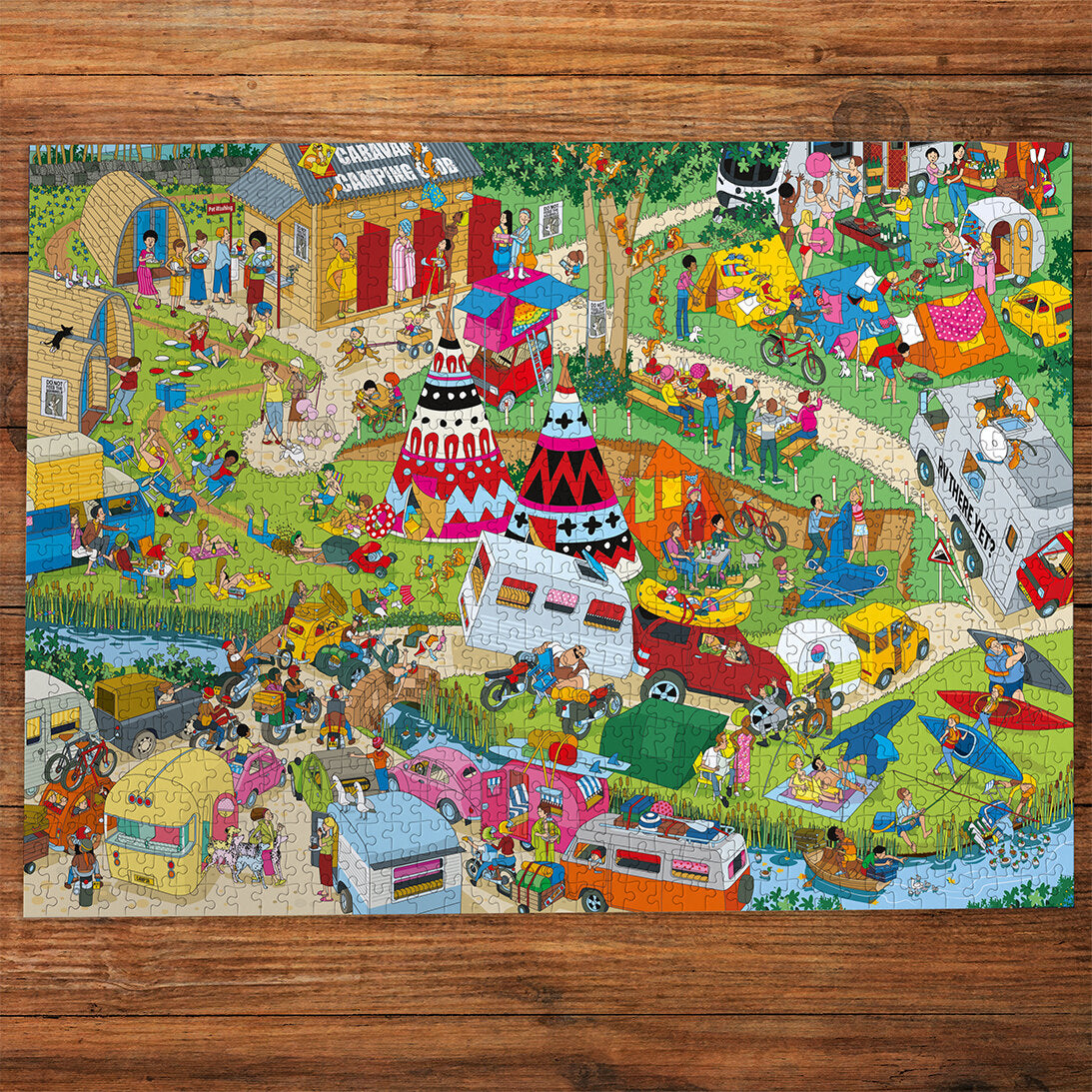 Jokesaws Campsite Capers 1000 Piece Jigsaw Puzzle by Gibsons made up on wooden table