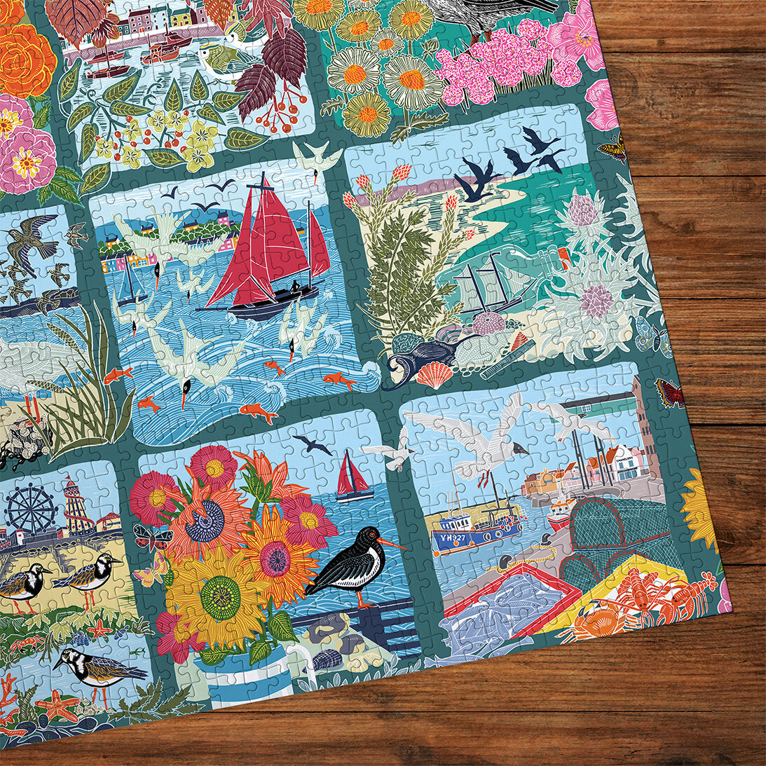 Coastal Calling 1000 Piece Jigsaw Puzzle by Gibsons made up detail on wooden table