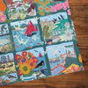 Coastal Calling 1000 Piece Jigsaw Puzzle by Gibsons made up detail on wooden table