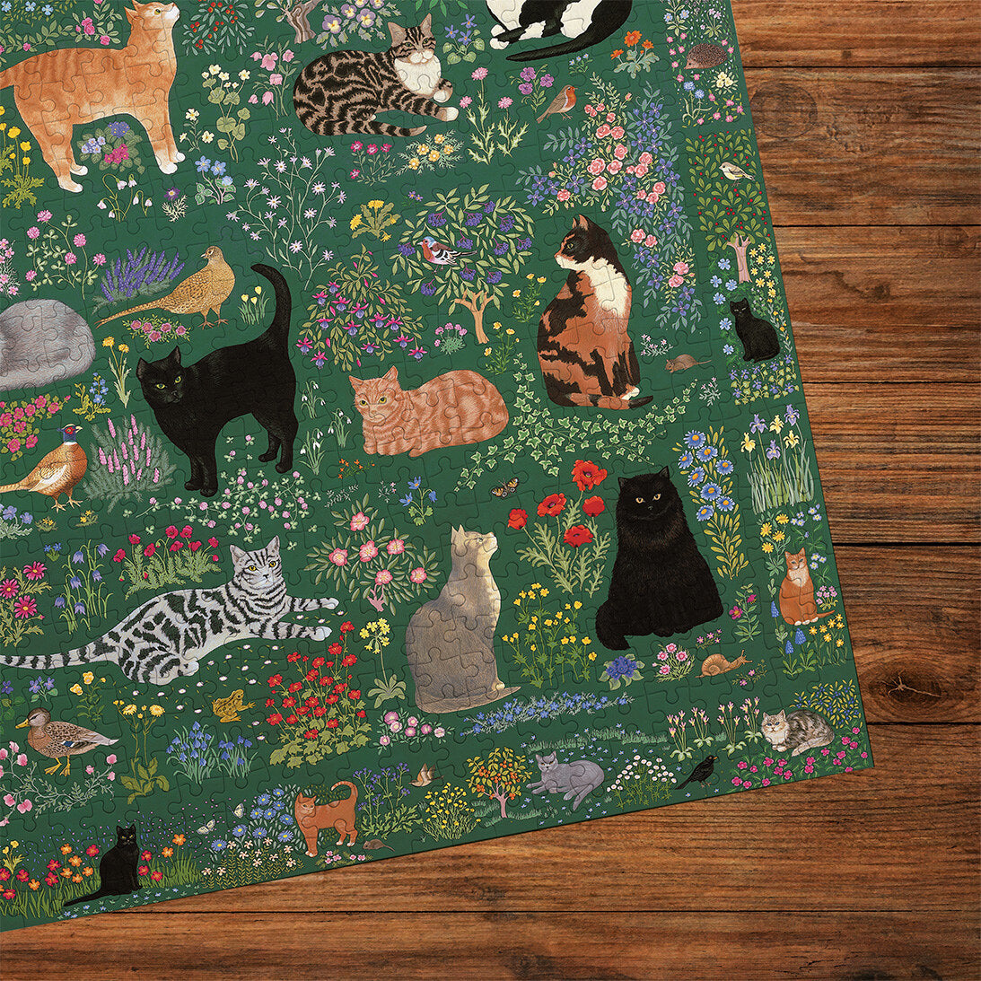 Tapestry Garden 1000 Piece Jigsaw Puzzle by Gibsons cropped on wooden table