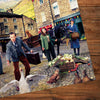 Jigsaw puzzle with a scene of people and animals on a wooden surface