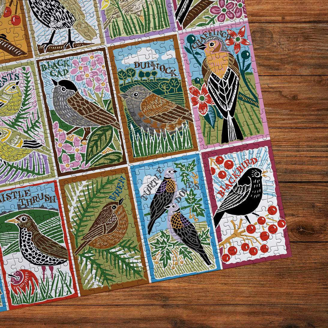 Colorful puzzle with bird illustrations on a wooden surface