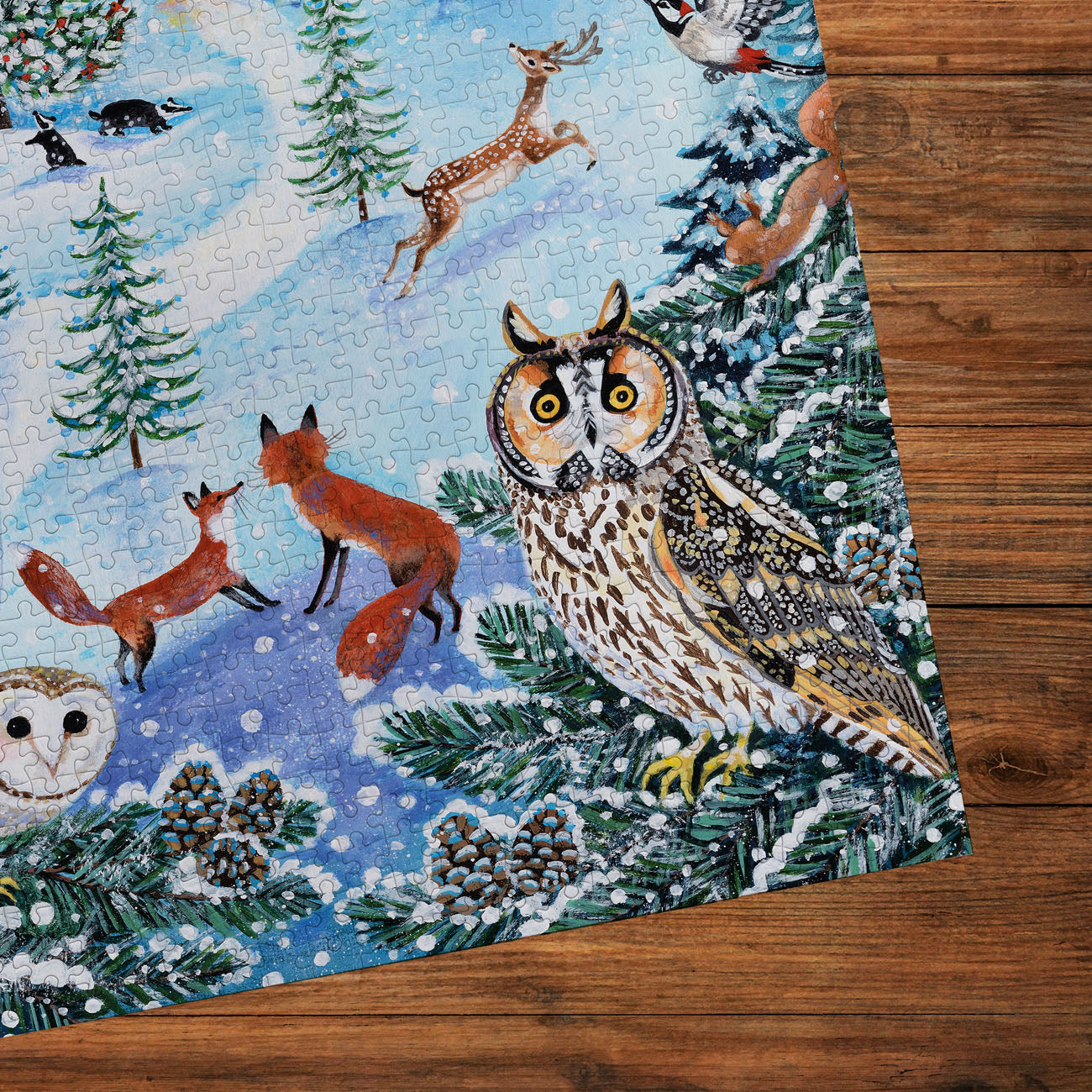 Jigsaw puzzle with winter scene featuring animals on a wooden surface