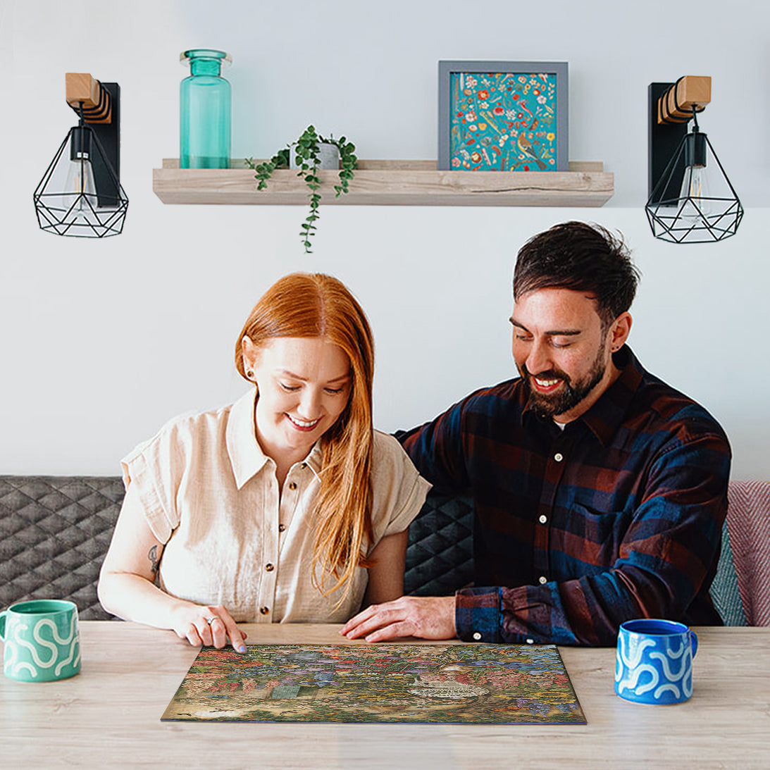 Man and woman working on a puzzle together at a table with decorative items in the background.