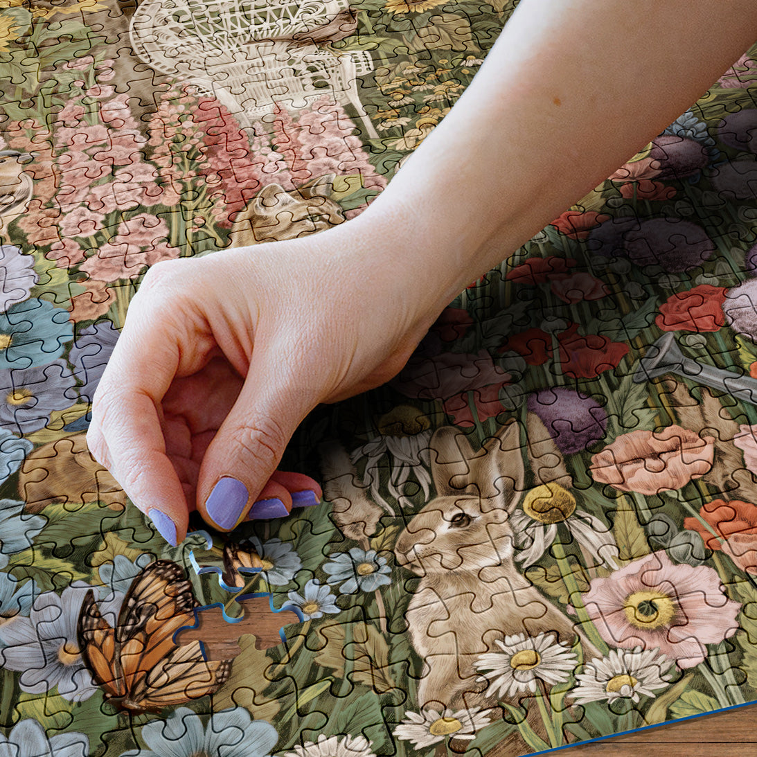 Hand placing a puzzle piece on a floral-themed puzzle