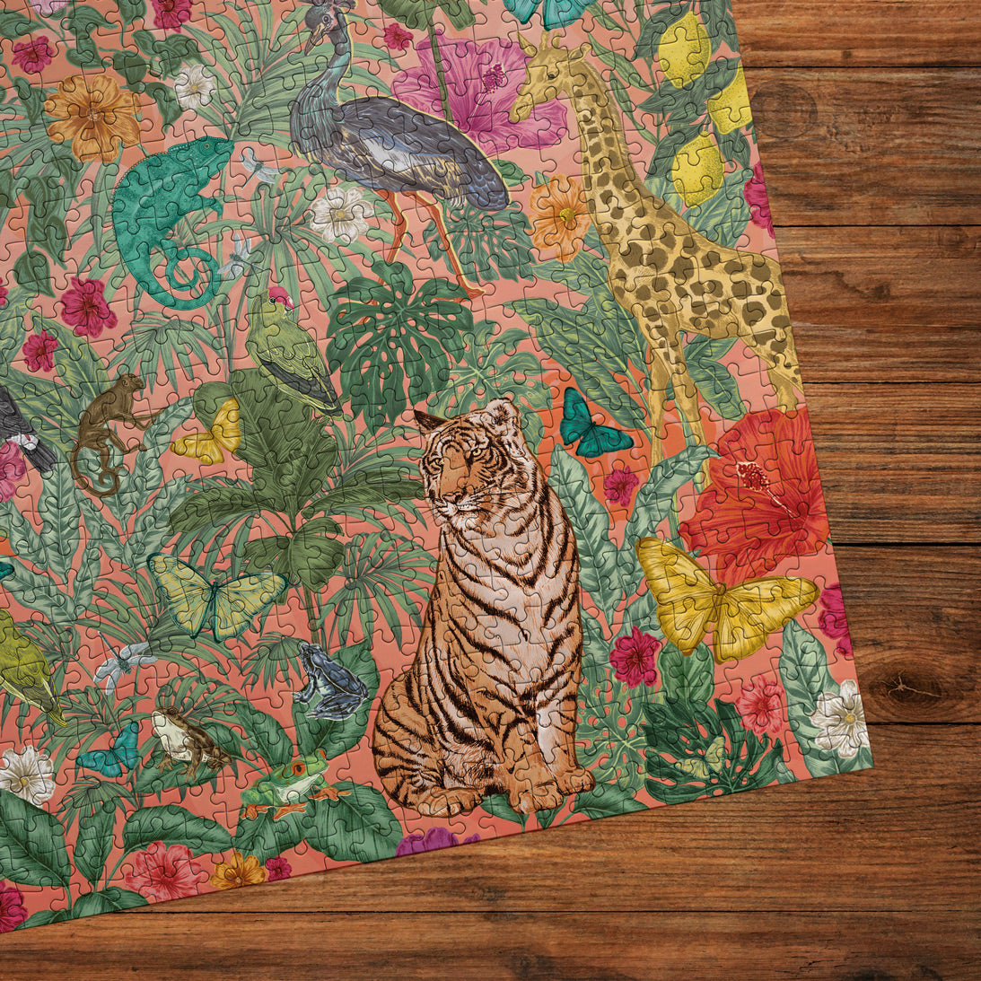 Colourful jigsaw with a tiger, peacock, and floral pattern on a wooden surface