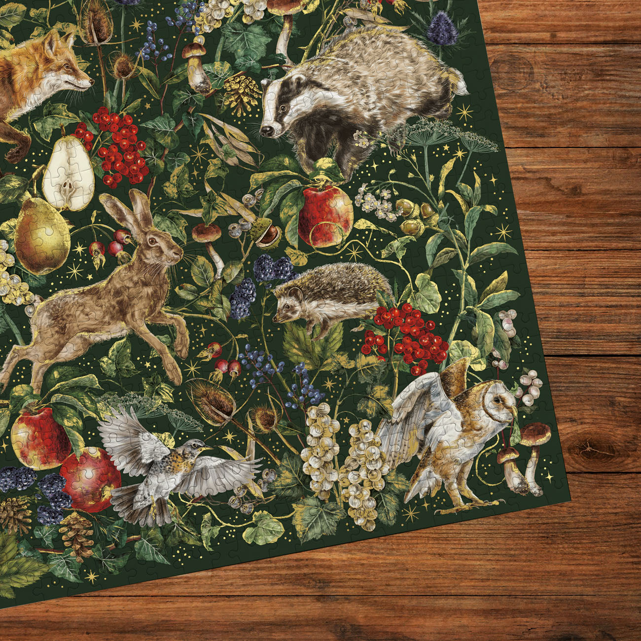 Decorative jigsaw with nature-themed design featuring animals and plants on a wooden surface