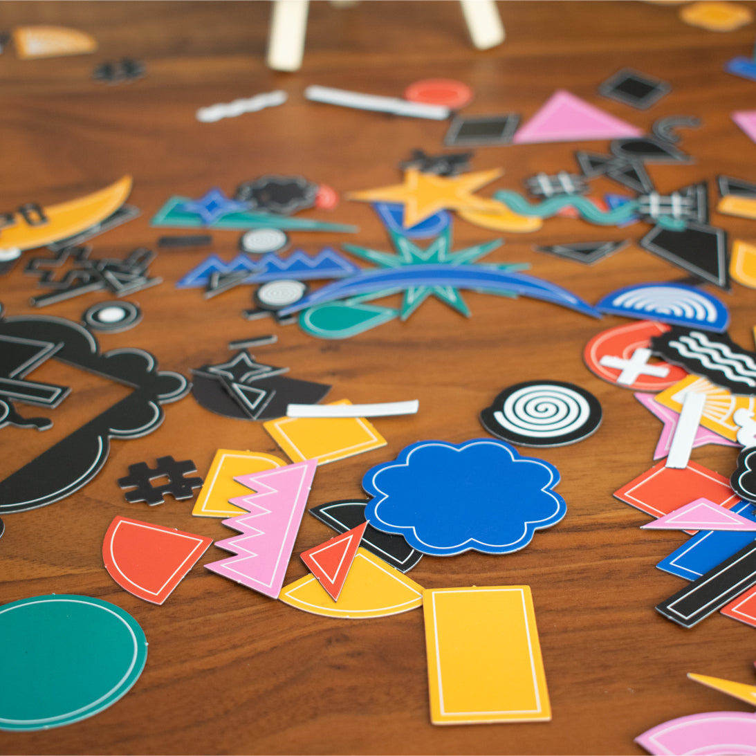Colourful magnetic cut outs on a wooden table