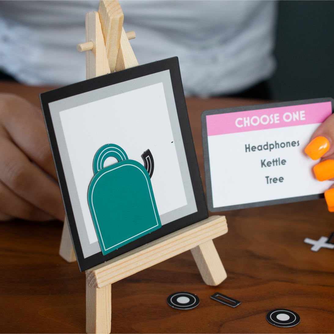 Teal backpack icon on a small easel with a decision card next to it.