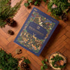 Backgammon game box with nature-themed design on a wooden floor surrounded by plants