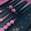 Pink dice and game pieces on a backgammon board with decorative elements.