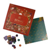 Bingo game set with bingo box, green card, and colourful markers on a white background