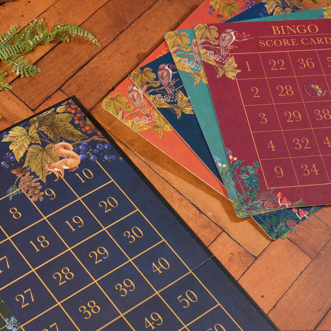 Bingo cards with floral designs on a wooden surface