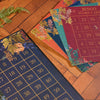 Bingo cards with floral designs on a wooden surface