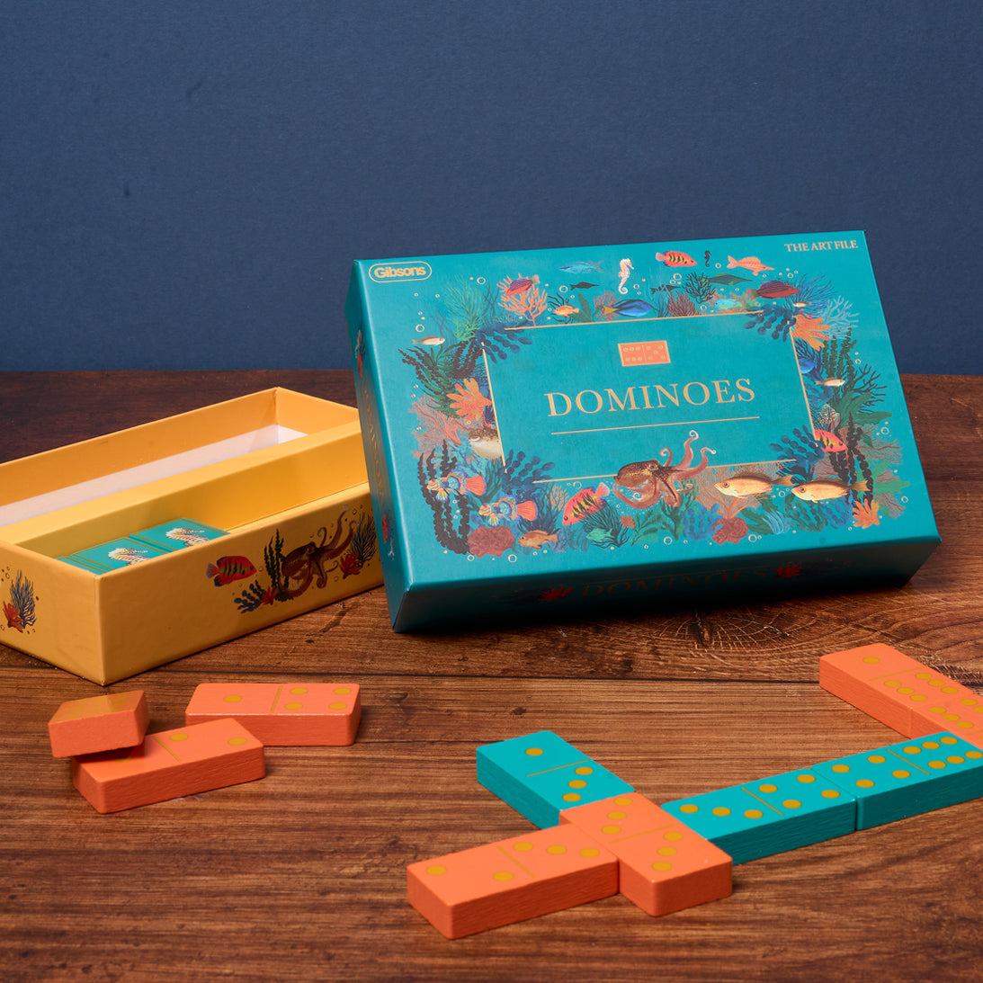 Dominoes set with colorful packaging on a wooden table