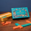 Dominoes set with colorful packaging on a wooden table
