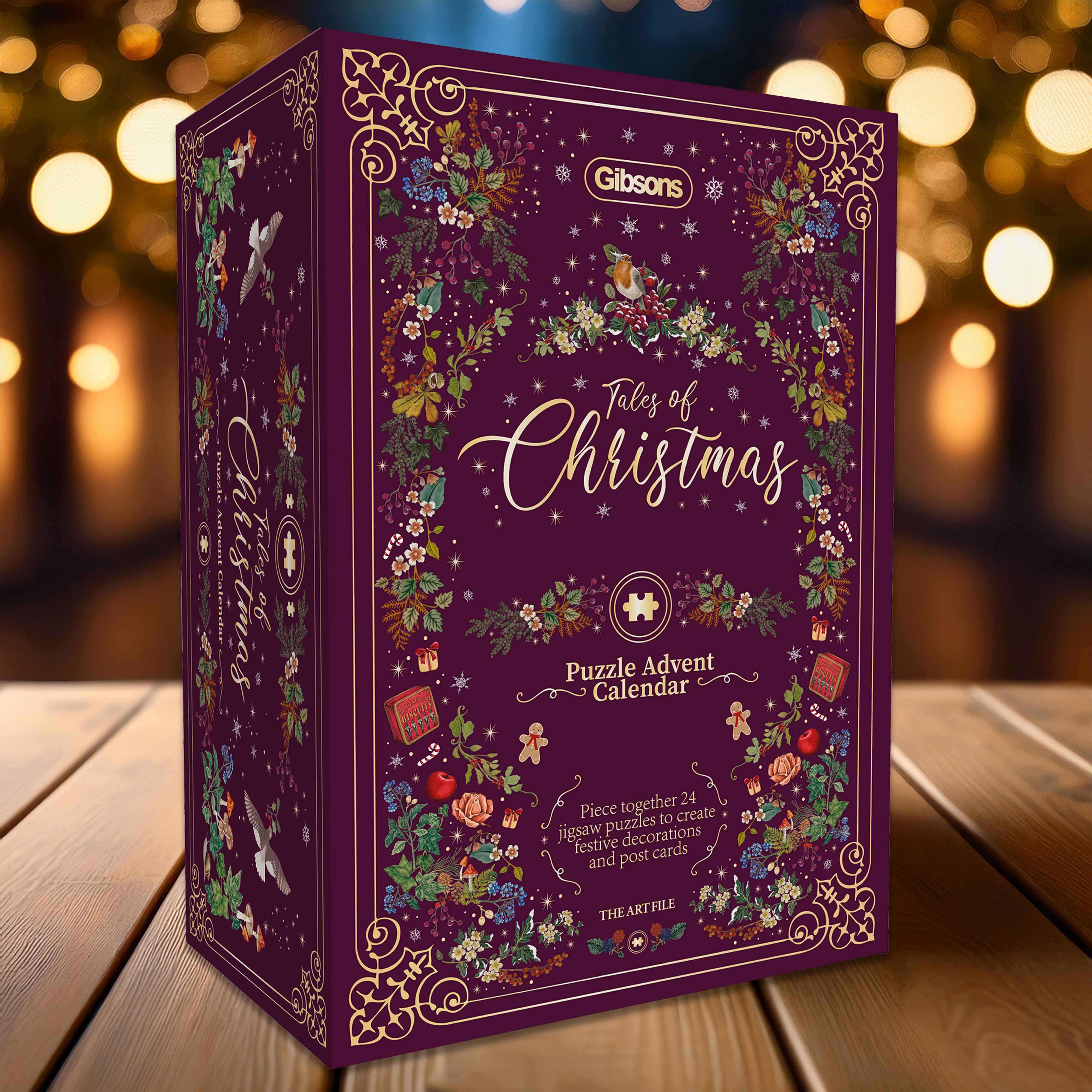 Gibson's Tales of Christmas puzzle advent calendar box on a wooden surface with blurred lights in the background