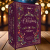Gibson's Tales of Christmas puzzle advent calendar box on a wooden surface with blurred lights in the background
