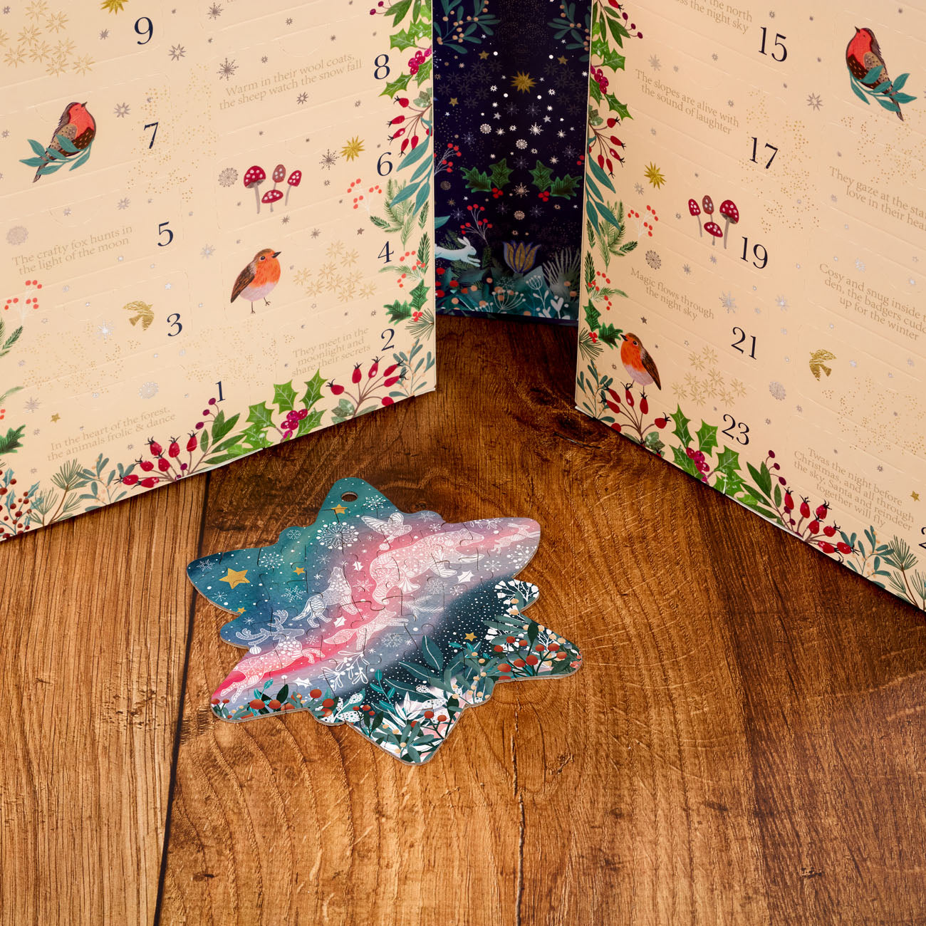 Open advent calendar showing a star-shaped jigsaw puzzle pull-out on a wooden surface