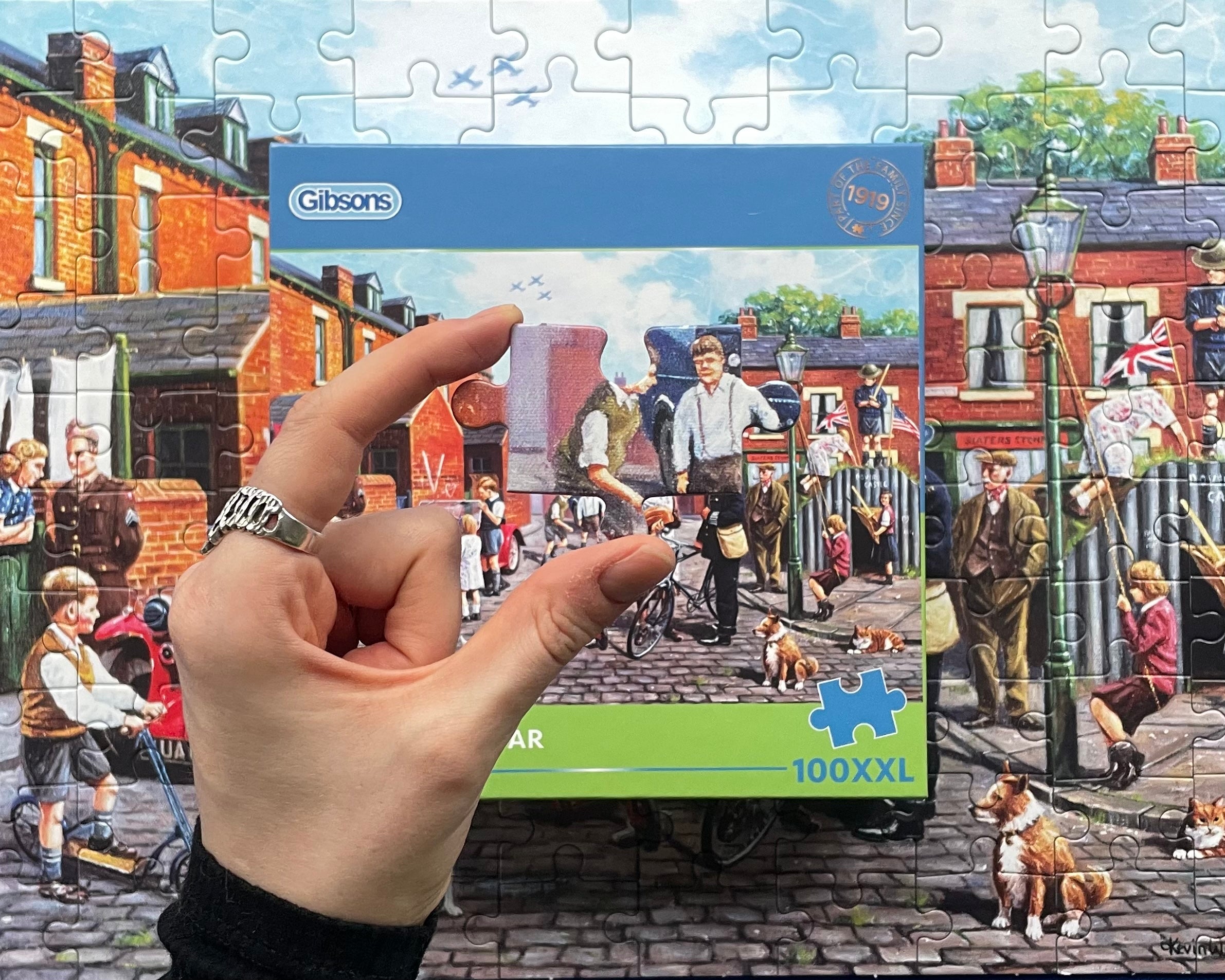 Gibsons puzzle box with a partially completed puzzle of a street scene.