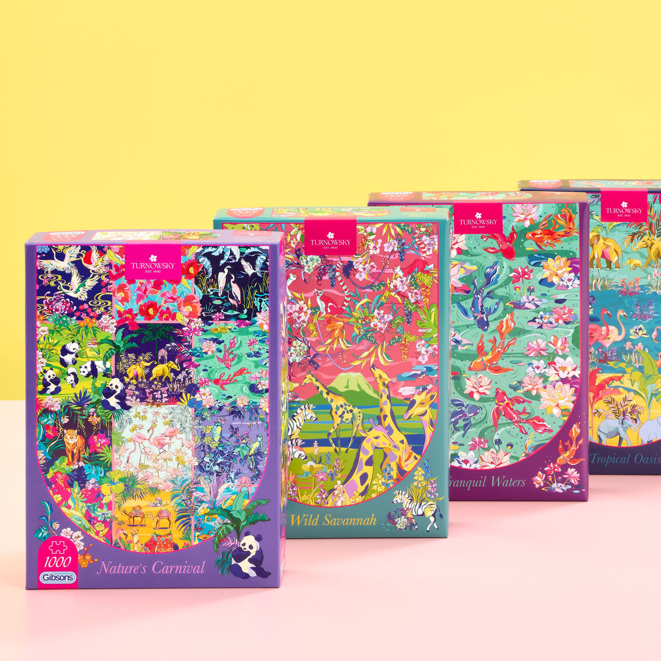 Four colorful jigsaw puzzle boxes arranged in a 2x2 grid on a light pink and yellow background. The boxes feature vibrant illustrated covers with animals and nature scenes, and each has a small red label at the top.
