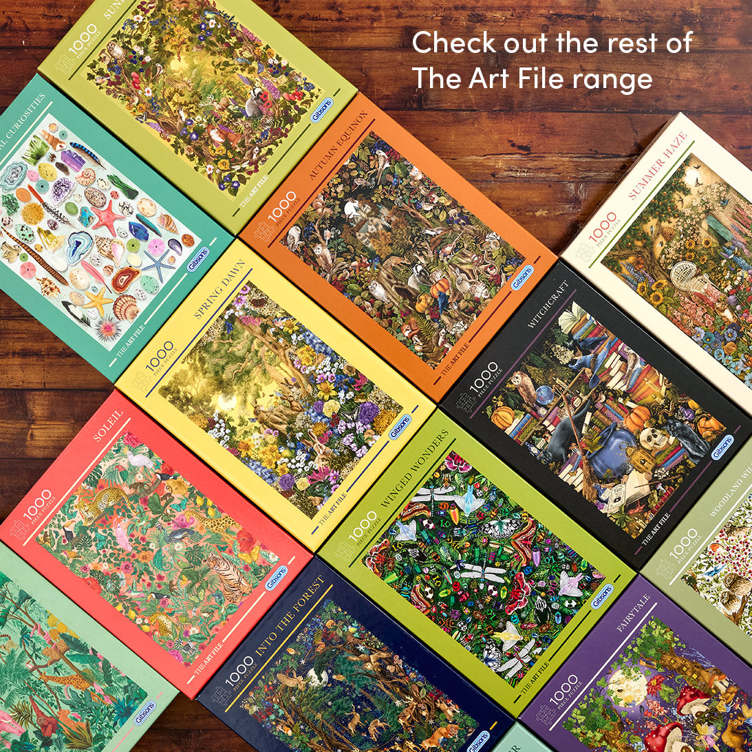 Collection of art file puzzles on a wooden surface with text promoting the range.