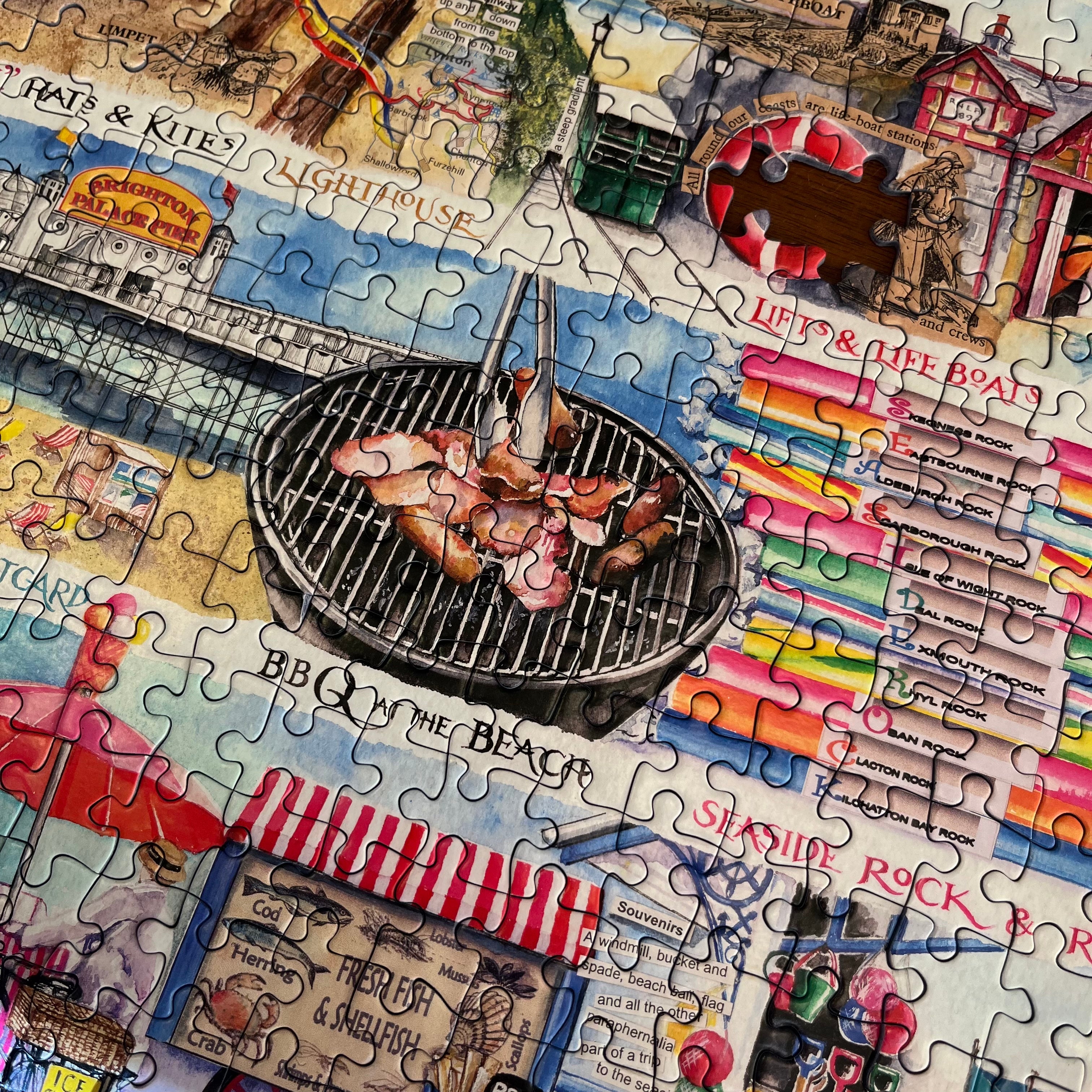 A completed jigsaw puzzle featuring a colorful coastal beach scene with a central charcoal grill holding raw and cooked meats, surrounded by illustrated storefronts, signs, boats, and beach elements.