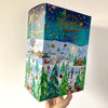 A person holding a Gibsons box of the Christmas advent calendar.