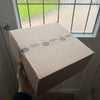 Gibsons Puzzle Subscription in hand at front door after being delivered.